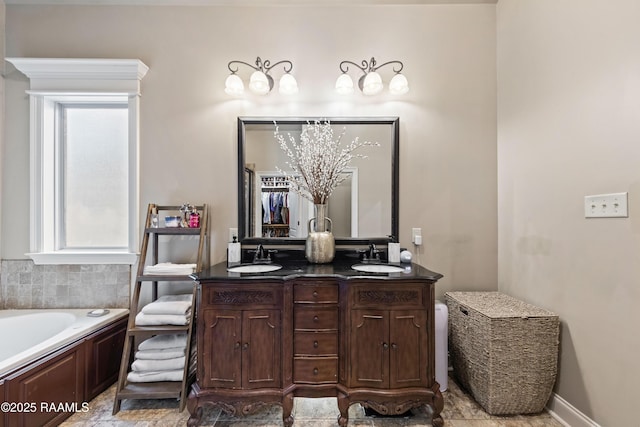 bathroom with a washtub and vanity