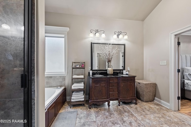 bathroom featuring vanity and a tub