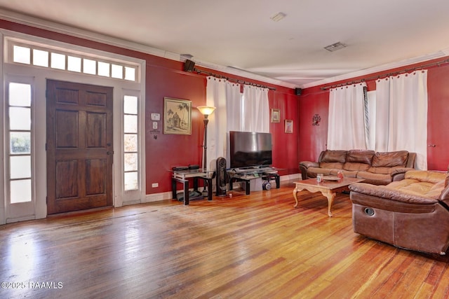 living room featuring hardwood / wood-style floors and crown molding