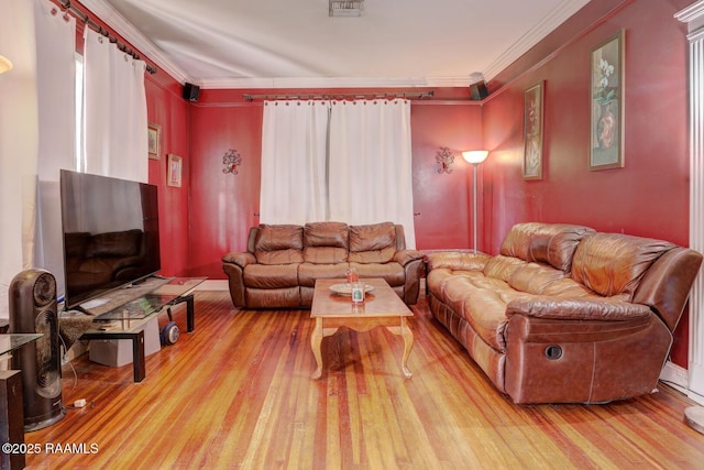 living room with light wood-type flooring and ornamental molding