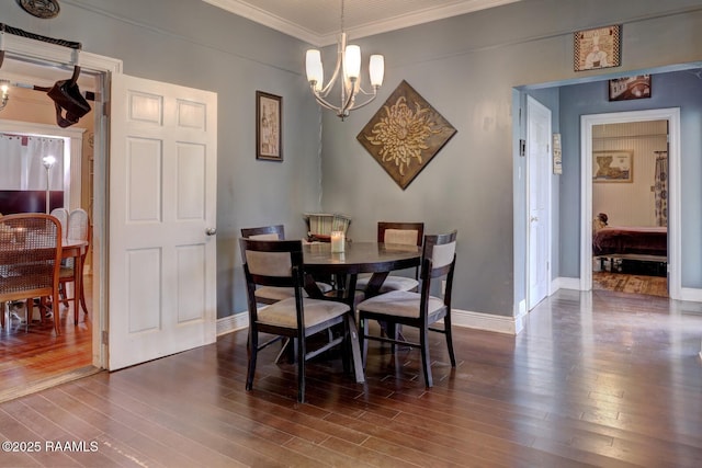 dining room with a chandelier, dark hardwood / wood-style flooring, and crown molding