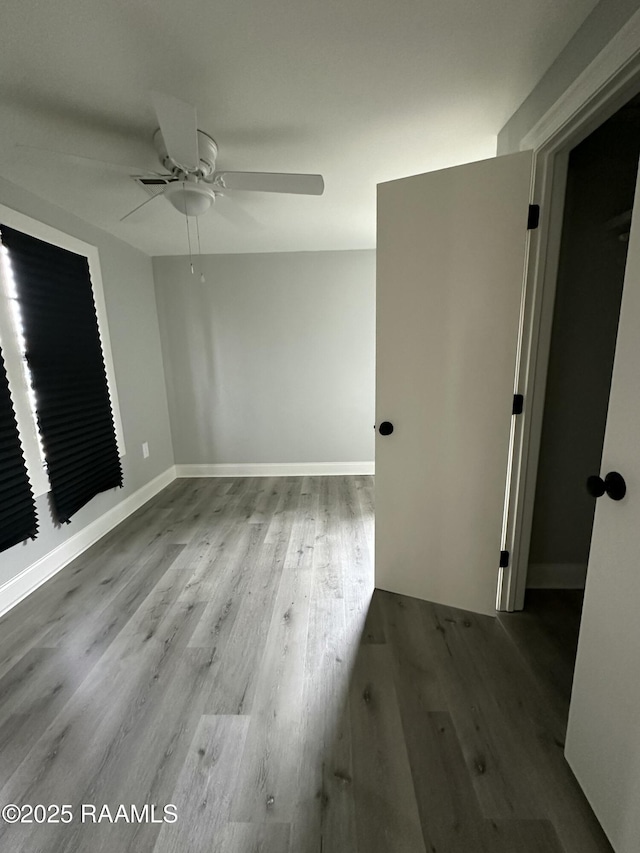 spare room featuring ceiling fan and light hardwood / wood-style floors