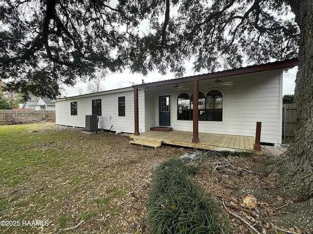 rear view of property with central AC unit, ceiling fan, a lawn, and a wooden deck