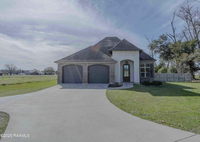 view of front of property featuring a garage and a front lawn