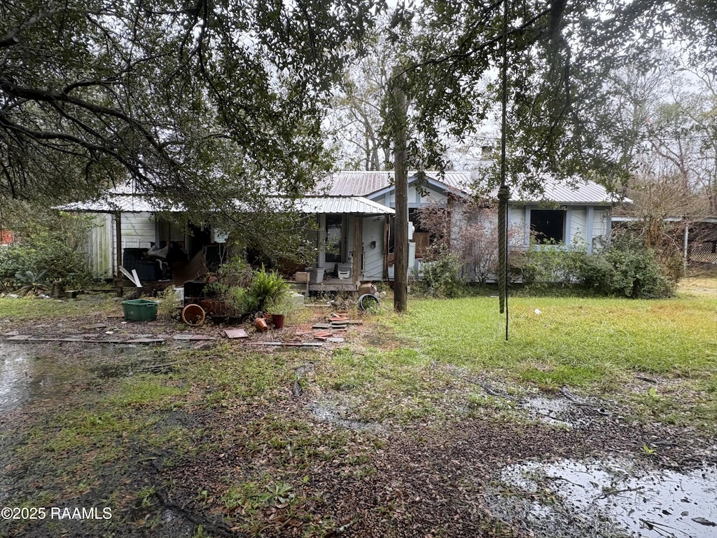 back of house with a lawn