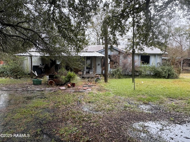 back of house with a lawn