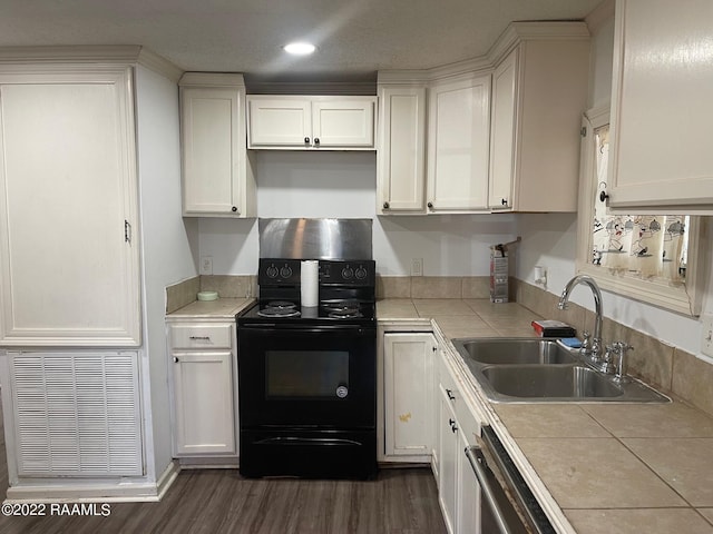 kitchen featuring white cabinets, tile countertops, black range with electric stovetop, and sink