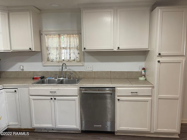 kitchen with white cabinets, stainless steel dishwasher, and sink