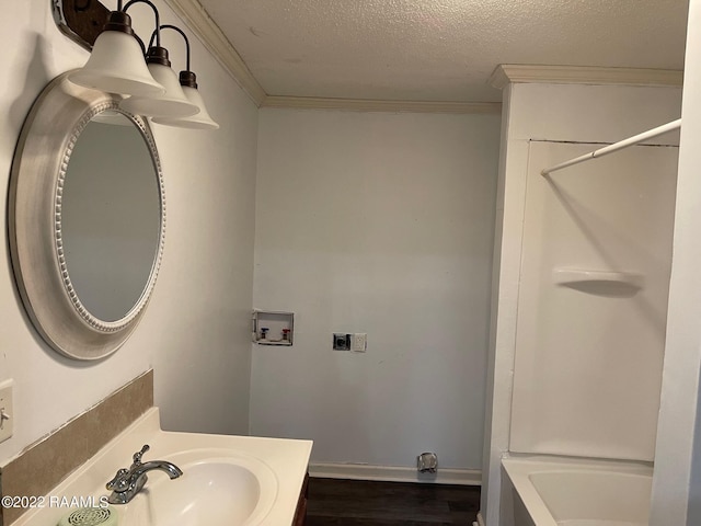 bathroom featuring hardwood / wood-style flooring, vanity, ornamental molding, and a textured ceiling