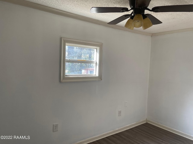 spare room featuring crown molding, ceiling fan, dark wood-type flooring, and a textured ceiling