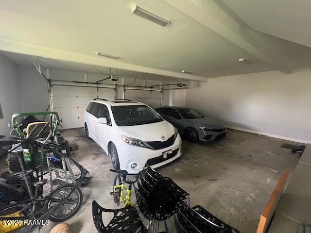 garage with a garage door opener and a carport