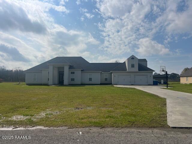 view of front of property with a garage and a front yard