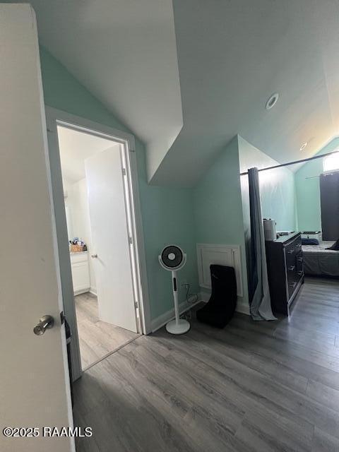 bonus room with lofted ceiling and wood-type flooring