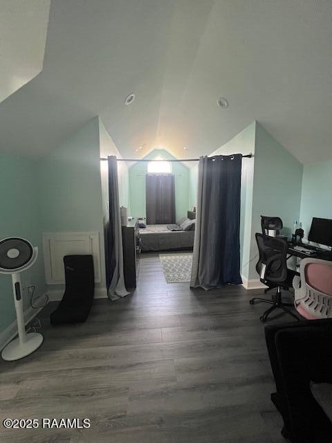 interior space with lofted ceiling and hardwood / wood-style flooring