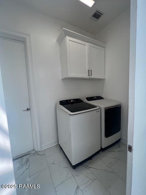 washroom with cabinets and separate washer and dryer