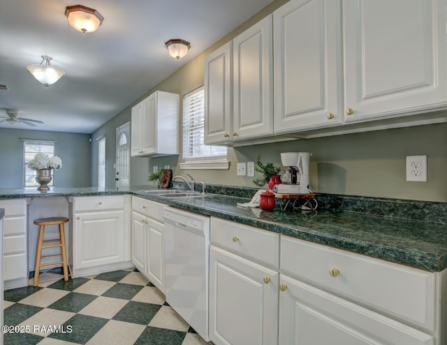 kitchen with dishwasher, white cabinetry, ceiling fan, and sink