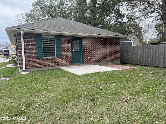 view of front of house with a front lawn and a patio