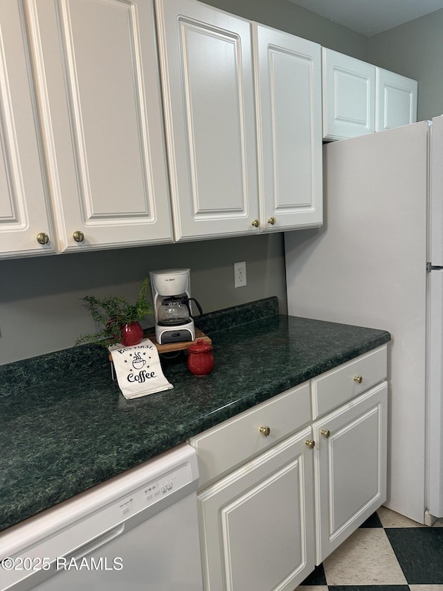 kitchen featuring white cabinetry and white appliances