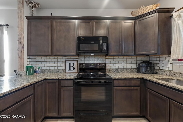 kitchen featuring light stone counters, backsplash, black appliances, and dark brown cabinetry