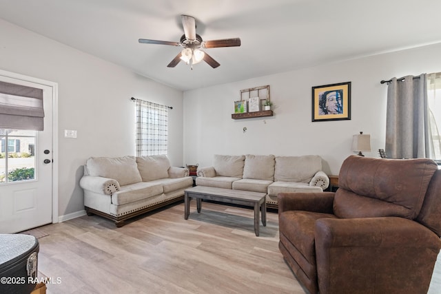 living room with ceiling fan, light hardwood / wood-style flooring, and plenty of natural light