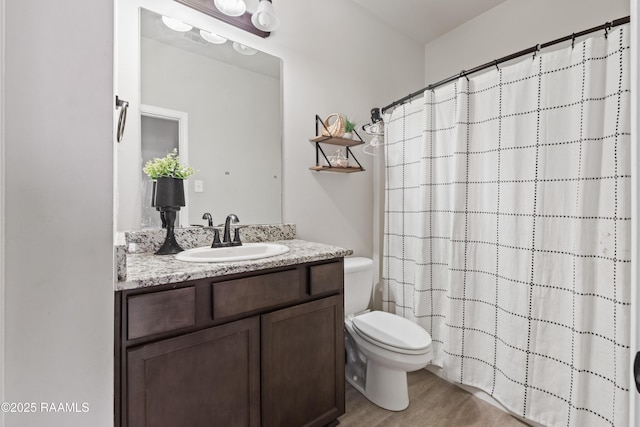 bathroom featuring a shower with curtain, toilet, vanity, and hardwood / wood-style flooring