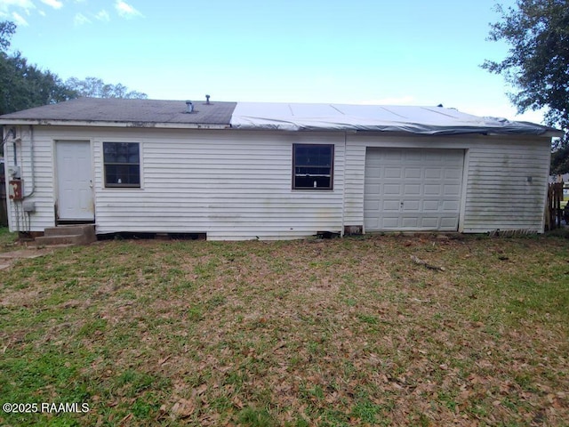 rear view of house featuring a yard