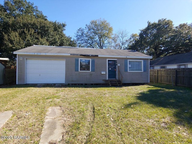 ranch-style home with a garage, an outbuilding, and a front lawn