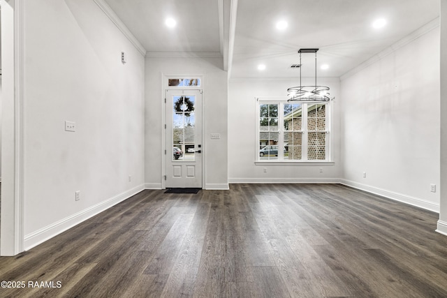 foyer with crown molding and dark hardwood / wood-style floors