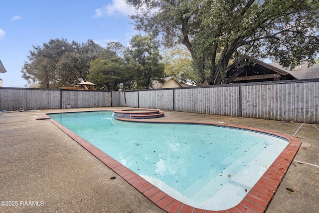 view of swimming pool featuring an in ground hot tub