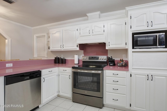 kitchen featuring custom exhaust hood, light tile patterned floors, ornamental molding, appliances with stainless steel finishes, and white cabinets