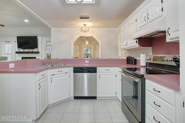 kitchen with sink, kitchen peninsula, white cabinets, and appliances with stainless steel finishes