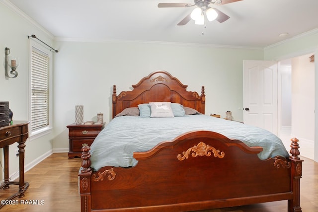 bedroom featuring multiple windows, ornamental molding, ceiling fan, and light hardwood / wood-style floors