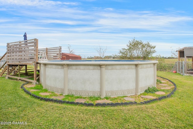 view of pool with a yard