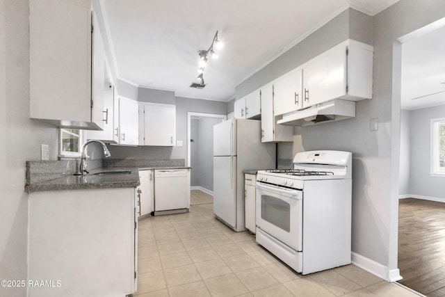 kitchen with light tile patterned flooring, white cabinetry, sink, and white appliances