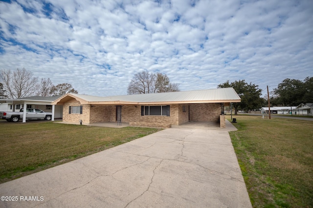 ranch-style home featuring a front lawn and a carport