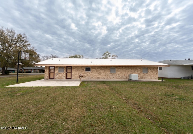 back of property featuring a lawn and a patio area