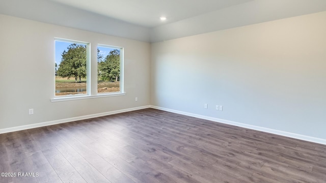 empty room featuring dark hardwood / wood-style flooring