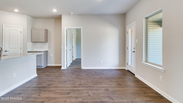 unfurnished living room with dark hardwood / wood-style floors