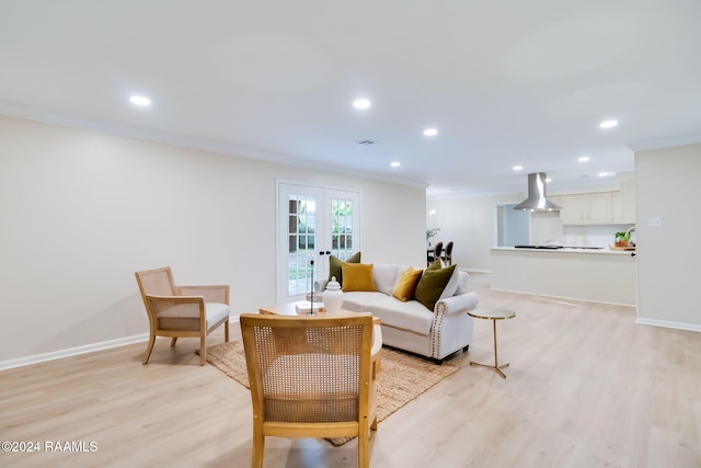 living room featuring french doors, ornamental molding, and light hardwood / wood-style floors