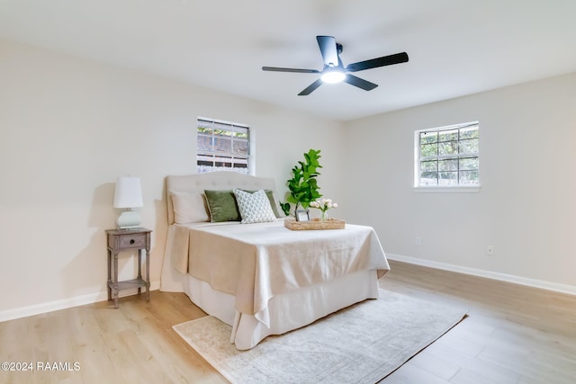 bedroom with ceiling fan and light hardwood / wood-style floors