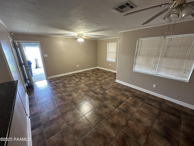 empty room with ceiling fan and crown molding