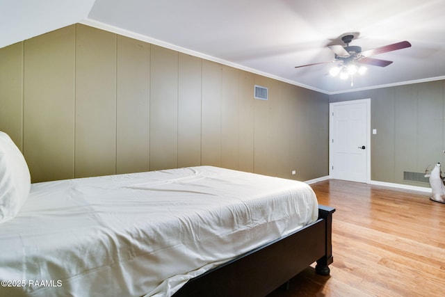 bedroom with crown molding, ceiling fan, and light hardwood / wood-style floors