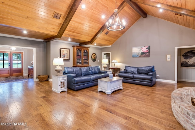 living room with beamed ceiling, high vaulted ceiling, a chandelier, and light hardwood / wood-style flooring