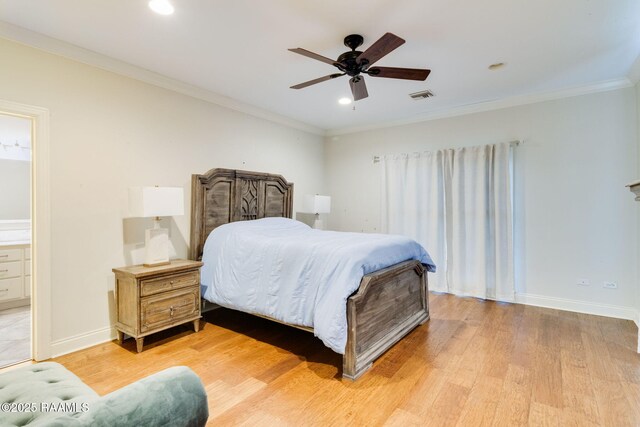 bedroom with connected bathroom, hardwood / wood-style floors, ornamental molding, and ceiling fan