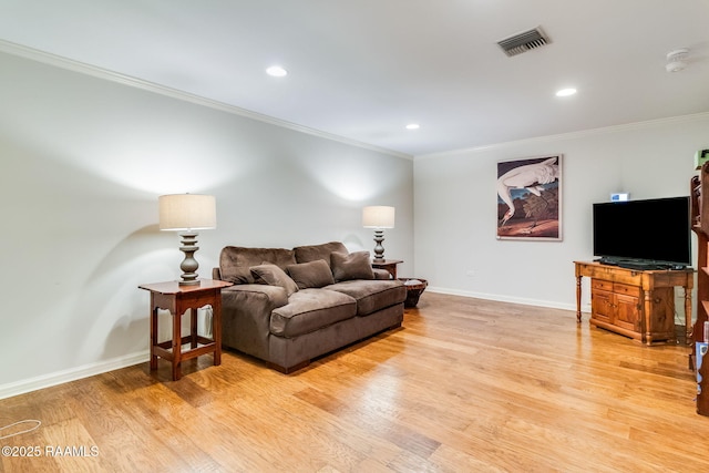 living room with crown molding and light hardwood / wood-style floors