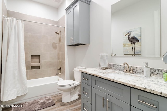 full bathroom with toilet, vanity, hardwood / wood-style flooring, and shower / tub combo with curtain