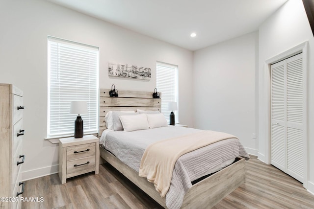 bedroom with hardwood / wood-style flooring and a closet