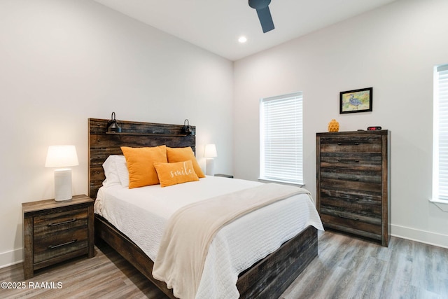 bedroom featuring hardwood / wood-style floors and ceiling fan