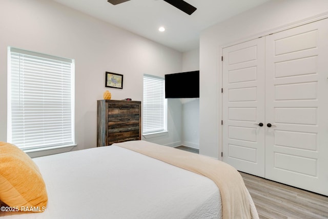 bedroom featuring wood-type flooring, a closet, and ceiling fan