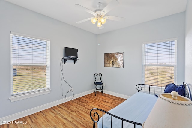 bedroom featuring hardwood / wood-style flooring and ceiling fan